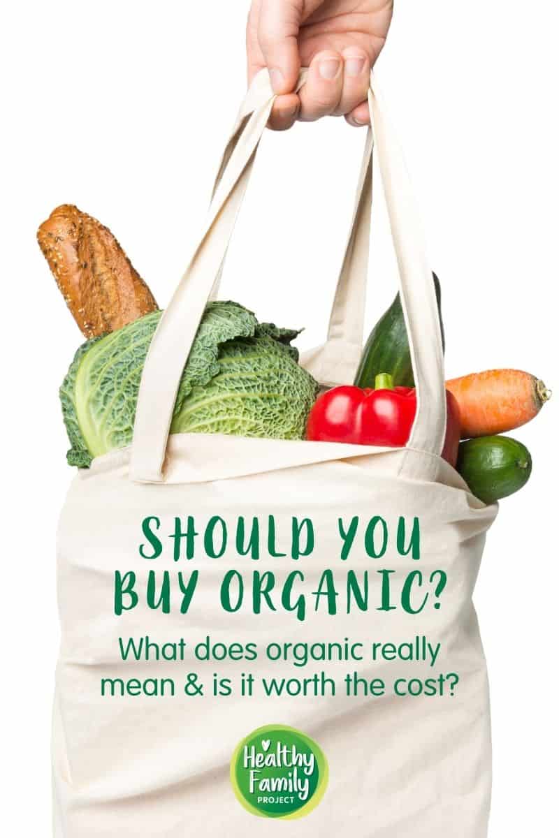 Hand holding white shopping back filled with fresh produce with text overlay.