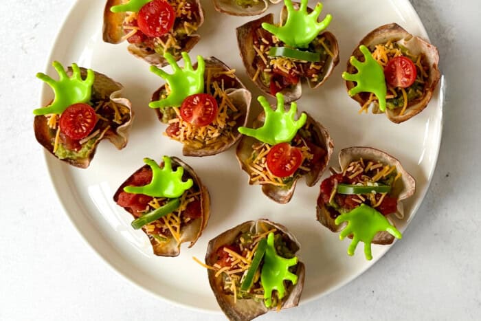 Wonton cups served with cheese, vegetables, and Halloween theme decorations.