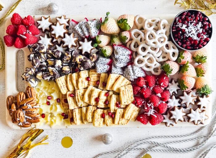 Sweet and Savory Snack Board with New Year's decorations.