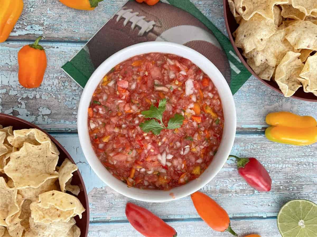 Homemade Salsa for game day gathering accompanied with chips.